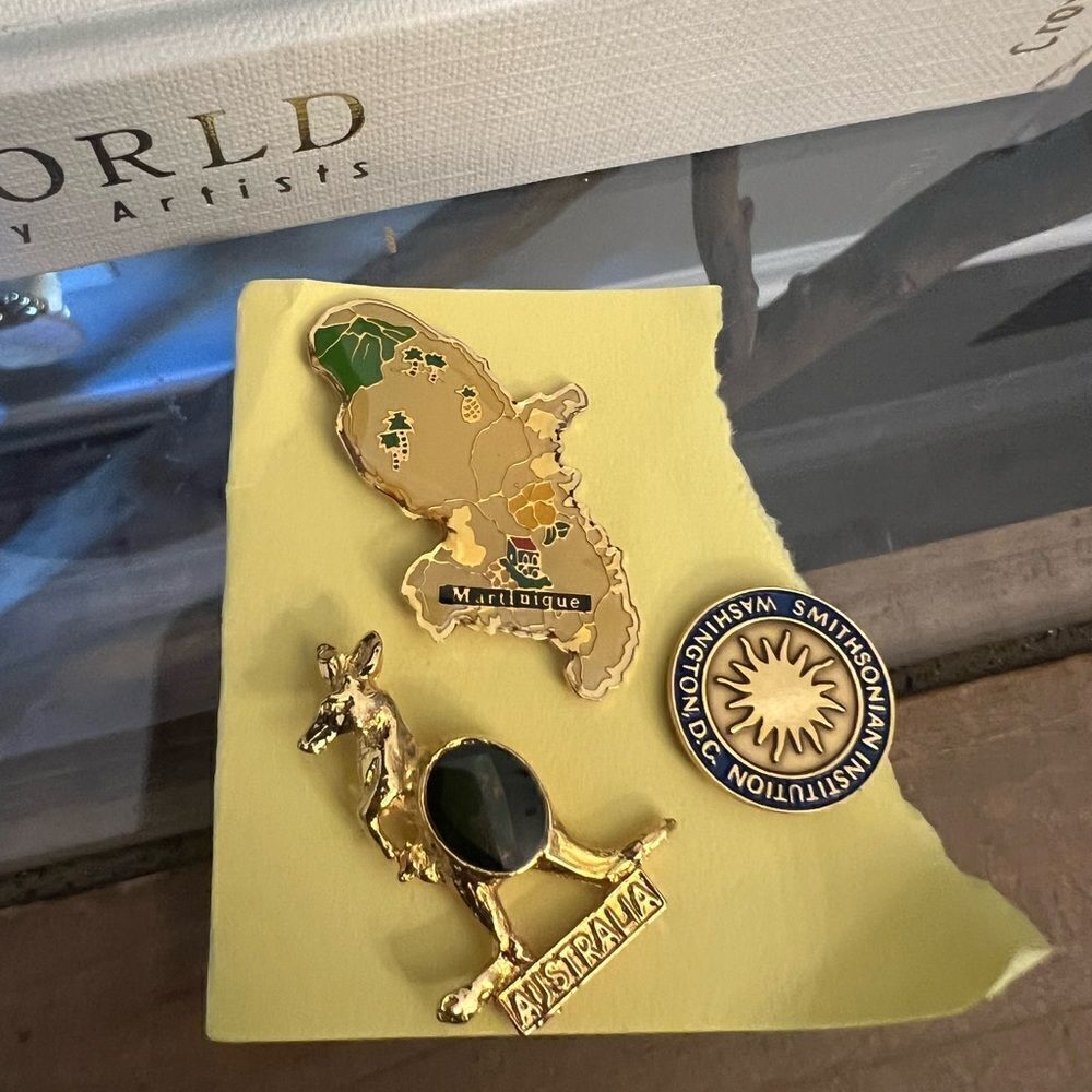 Three vintage gold tone pins. Australia, Smithsonian, Martinique.